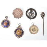 A collection of silver brooches and medals to include ' For King And Empire Services Rendered ' ,