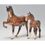 A good 20th century Beswick horse porcelain figurine of a chestnut bay coloured coat with raised