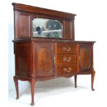 An early 20th Century Edwardian mahogany sideboard credenza having a mirrored back panel, with a