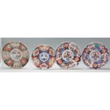 A group of four 19th Century Japanese Imari cabinet / wall charger plates to include a pair of