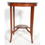 An Edwardian mahogany inlaid oval lamp table. Raised on square tapering legs with central circular