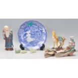 A collection of Chinese ornaments to include a blue and white transfer printed plate, a carved