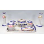 A vintage 20th Century Japanese ceramic dressing table set having blue borders with pink floral