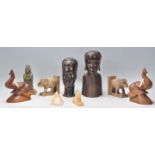 A collection of tribal items to include two African carved ebonised hardwood busts, two carved stone