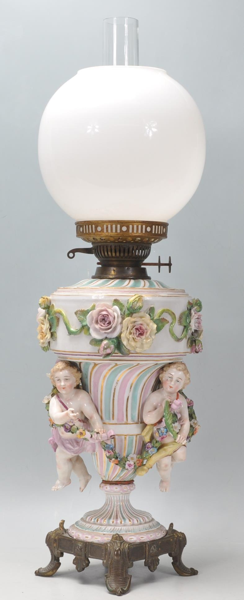 An antique German porcelain Dresden / Sitzendorf style oil lamp of large proportions, the body