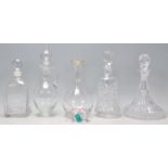 A mixed group of five glass decanters of various shapes and sizes to include a etched ships