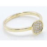 An 18ct gold ring having a round head set with a cluster of diamonds to the head. Marked 18ct to the