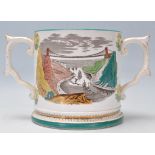 A 19th century Staffordshire twin handled loving cup - mug being cream glazed with polychrome