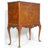 A good Queen Anne style walnut cocktail cabinet on stand. The walnut double door cabinet enclosing a