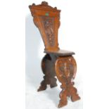An Italian antique Sgabello chair having a panelled seat with an intricately carved scallop shell