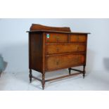 A 1920's Jacobean revival vintage oak dressing chest of drawers having a rail back above two short