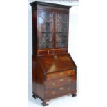 A 19th Century George III mahogany bureau bookcase  having a bank of three drawers with a brass