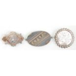 A group of three Victorian silver brooches having 9ct gold detailing. To include a brooch having