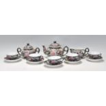 A 20th century Chinese ceramic tea / dinner service in black ground and polychrome floral