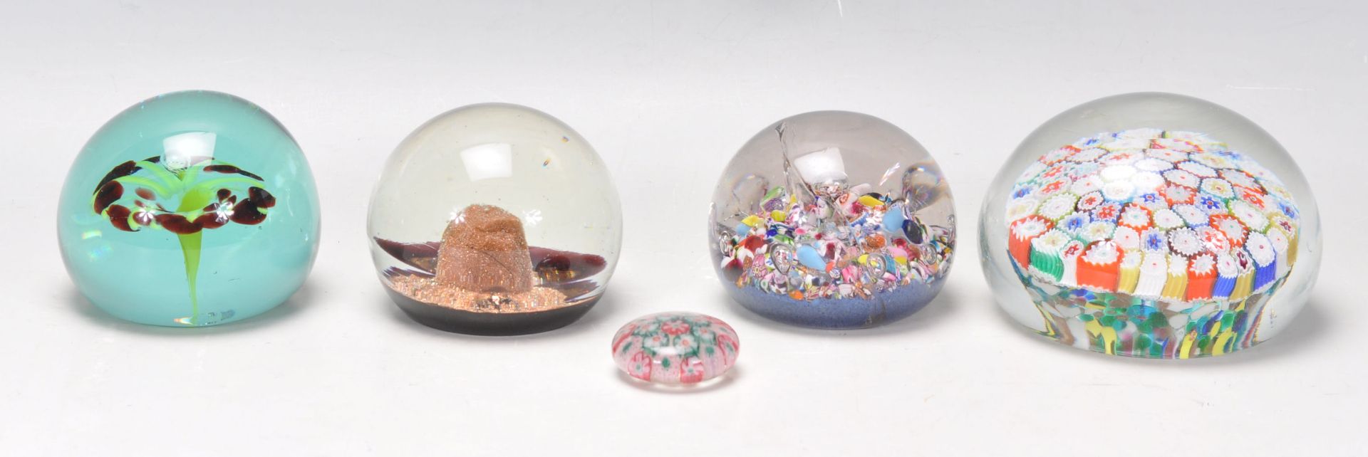 A group of five glass paperweights to include millefiori and bubble examples, one bearing original