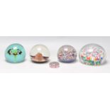 A group of five glass paperweights to include millefiori and bubble examples, one bearing original
