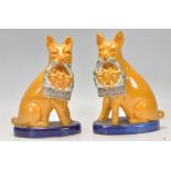 A nice pair of 19th Century English pig figures finished in yellow with both carrying a basket of