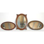 A group of three vintage oval mirrors dating from the early 20th Century to include an oak beaded