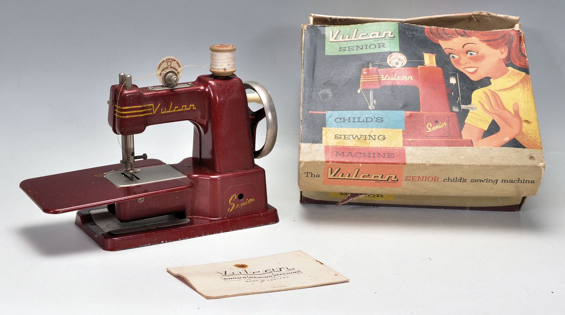 A vintage 20th Century Vulcan Senior childs sewing machine. Appears complete in the original box.