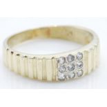 A yellow gold ring set with nine round cut diamonds to the square head with stepped shoulders.