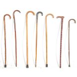 A mixed group of seven vintage and later walking sticks to include two crook handle examples