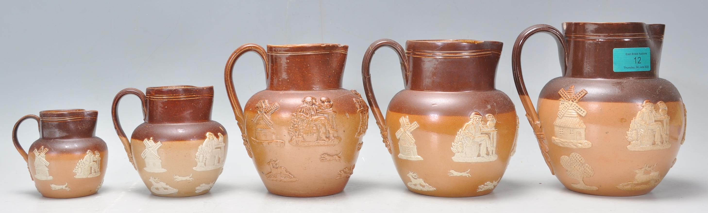 A group of five graduating 19th Century Doulton Lambeth stoneware jugs having applied raised white - Image 3 of 7