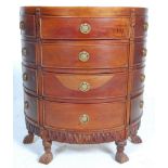 An Indian hard wood demi-lune multi chest of drawers having a sunburst top with round brass