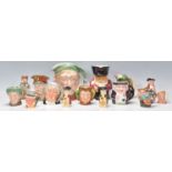 A mixed group of Toby Character jugs of varying sizes to include Beswick Scrooge, Royal Doulton