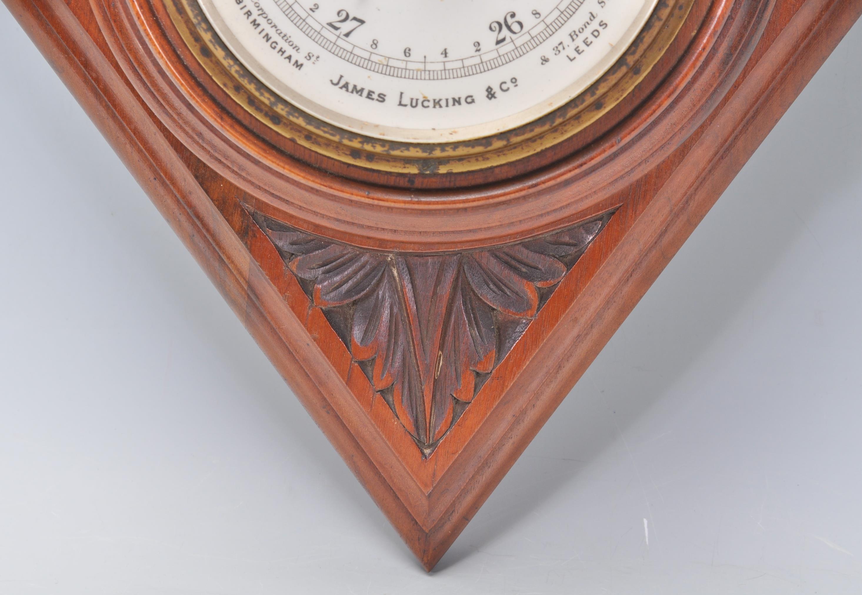 An early 20th Century carved oak barometer of lozenge shaped form having an enameled central round - Image 4 of 5