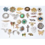 A large collection of costume jewellery brooches to include rhinestone floral set, yellow tone