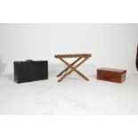 Two vintage leather suitcases mounted on a vintage metamorphic folding wooden slatted suitcase