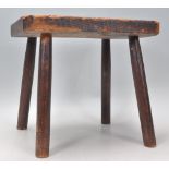 A 19th Century antique elm stool having a rectangular top raised on turned legs. 28cm x 31cm x