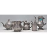 A collection of Georgian pewter ware to include a footed teapot with a raspberry finial, a table