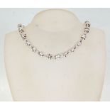 A Links Of London style silver necklace having round links with double rings throughout and a T-