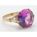 A hallmarked 9ct gold 1970's synthetic sapphire ring. The ring set with a large round mix cut