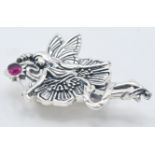A stamped 925 silver brooch in the form of a fairy set with a round cut rubellite stone. Pendant