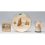 A group of three Royal Doulton ceramics to include a having painted cabinet plate decorated with