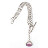 A late Victorian silver hallmarked double albert chain complete with an amethyst spinning fob and