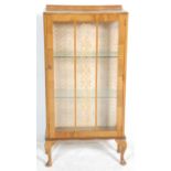 An early 20th Century Art Deco walnut display china cabinet, glazed single door with flanked by