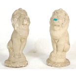 A matching pair of stone lion garden ornaments in standing position. 55cm high.