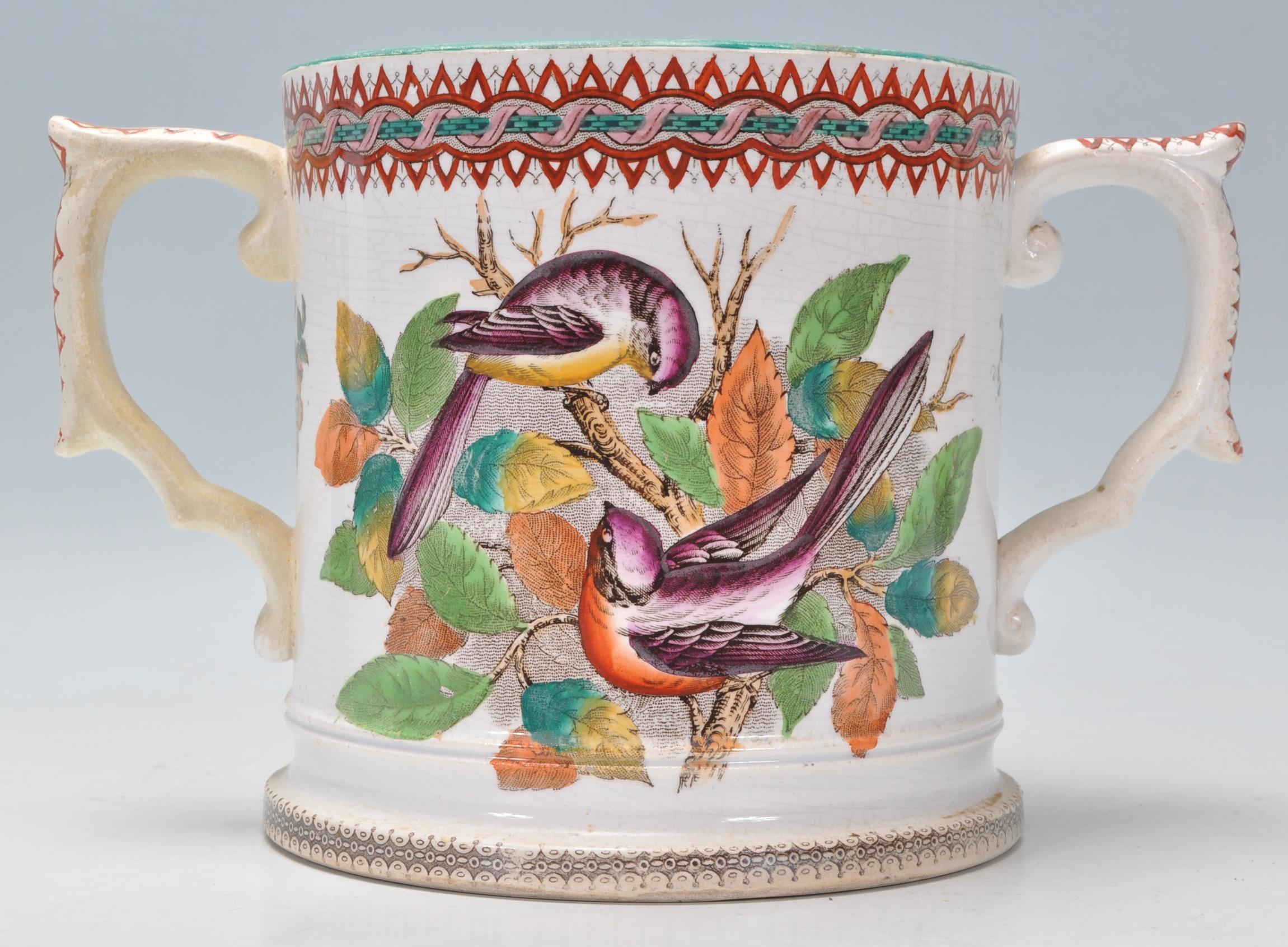 A 19th century Victorian Staffordshire twin handled marriage loving cup - mug being cream glazed