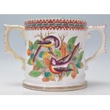 A 19th century Victorian Staffordshire twin handled marriage loving cup - mug being cream glazed