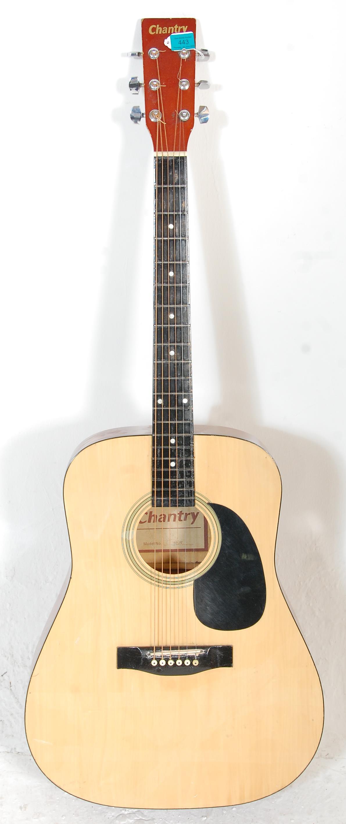 A good Chantry made acoustic guitar having a black scratch board inlaid fret board and chrome tuning
