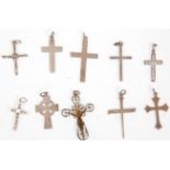 A collection of ten silver crucifix pendants to include a range of different designs to include a