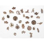 A collection of vintage and antique silver charms to include a variety of objects including a