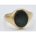 A 9ct yellow gold Gentleman's ring set with an oval Blood stone panel. Hallmarked for London date