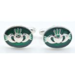 A pair of stamped 925 silver gentleman's cufflinks having blue enamelled Claddagh design oval heads.