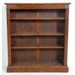 A 19th Century Victorian oak open fronted book case having a chamferred top with applied carved