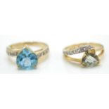 2 hallmarked 9ct gold and gem set rings. One with a blue heart cut gem having gem set shoulders, the