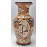 A large 20th Century Japanese vase of baluster form having a brown ground with incised florals and